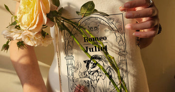 Woman holding Romeo and Juliet acrylic book vase with flowers inside