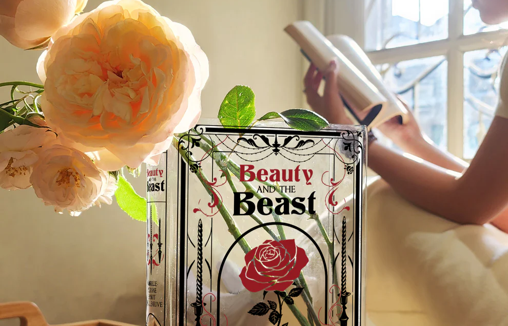 Beauty and the Beast book vase with roses, sunlight, person reading by window