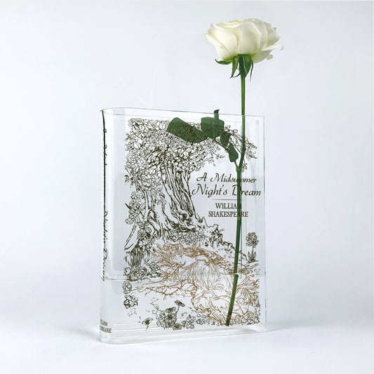 Acrylic book-shaped vase with A Midsummer Night's Dream cover and a single white rose