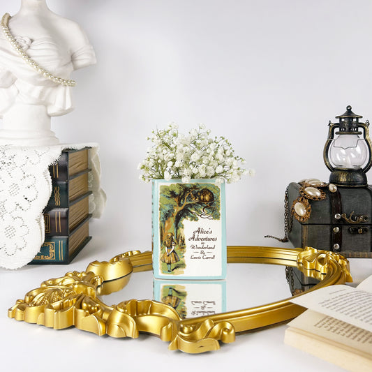 Alice's Adventures in Wonderland ceramic book vase with baby's breath flowers on ornate mirror