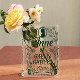 Anne of Green Gables acrylic book vase with flowers on a pink textured table
