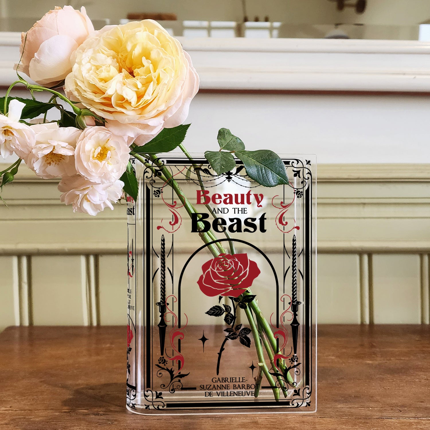 Beauty and the Beast acrylic book vase with roses on wood table, floral decor