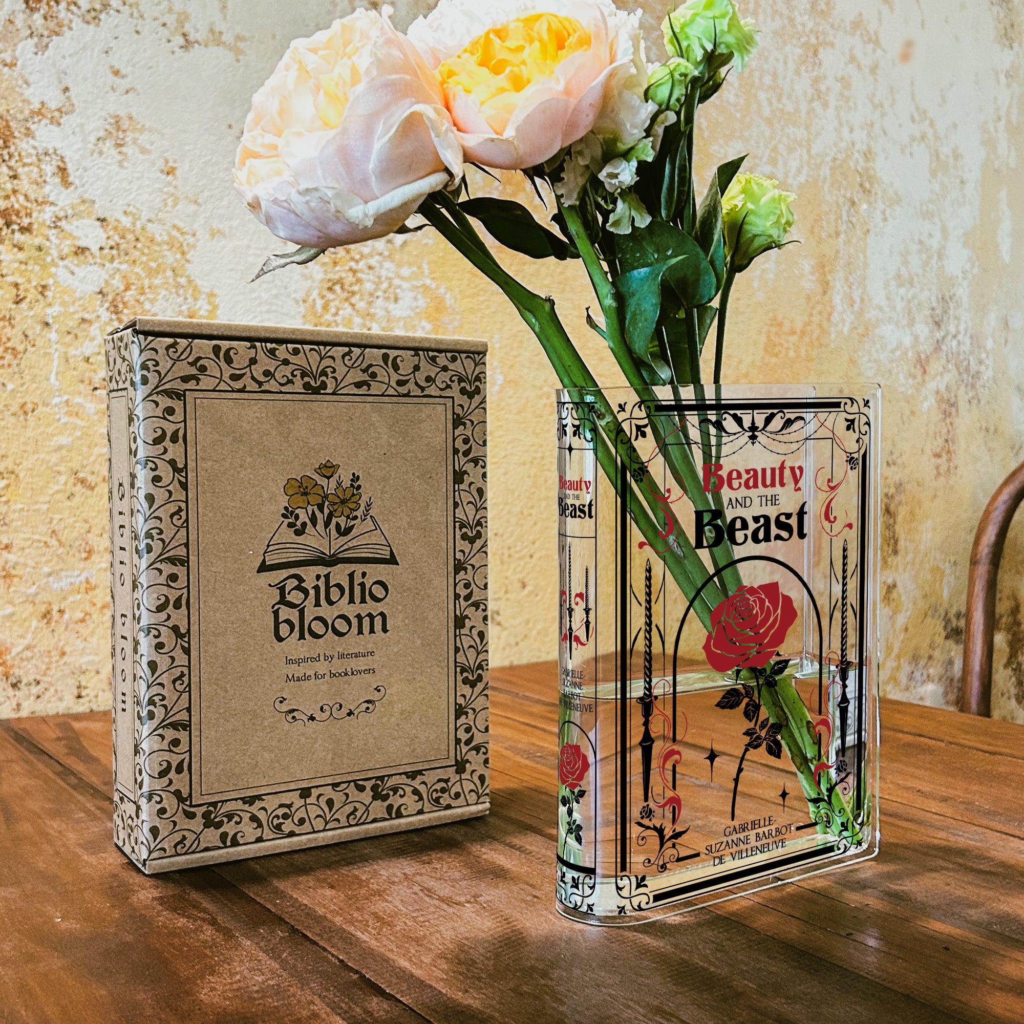 Beauty and the Beast acrylic book vase with roses on wooden table, Biblio Bloom box beside