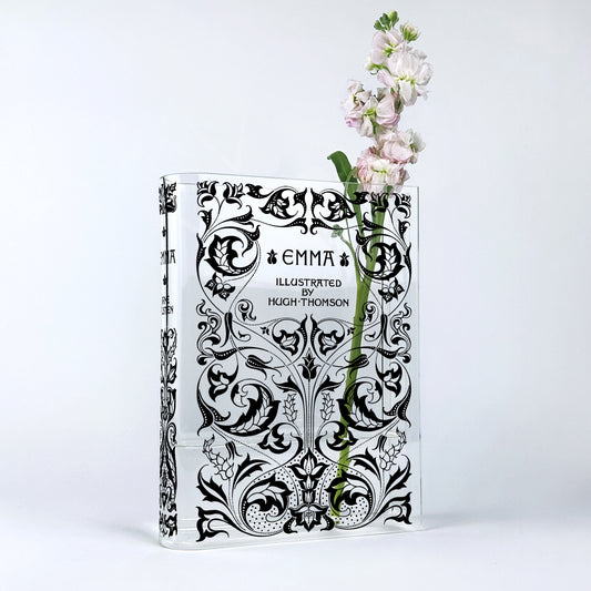 Acrylic book vase shaped like Emma 1896 edition with black floral design and pink flowers