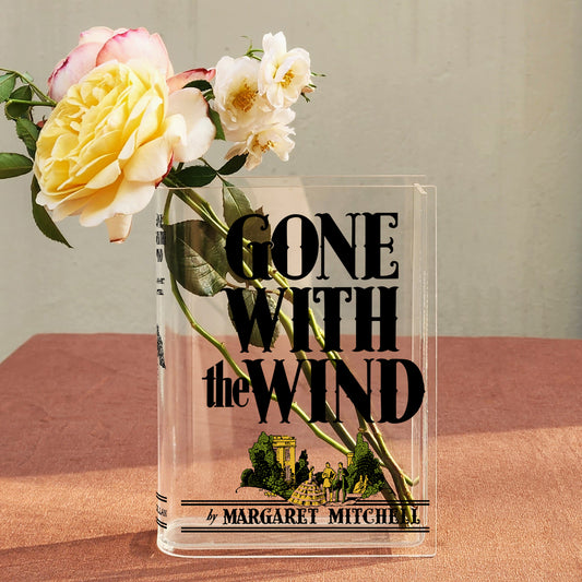 Gone With the Wind acrylic book vase with fresh roses on a brown table