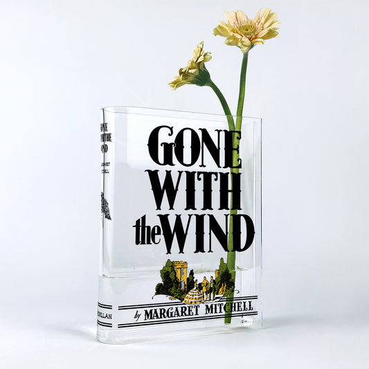 Gone With the Wind acrylic book vase with yellow gerbera flowers on white background