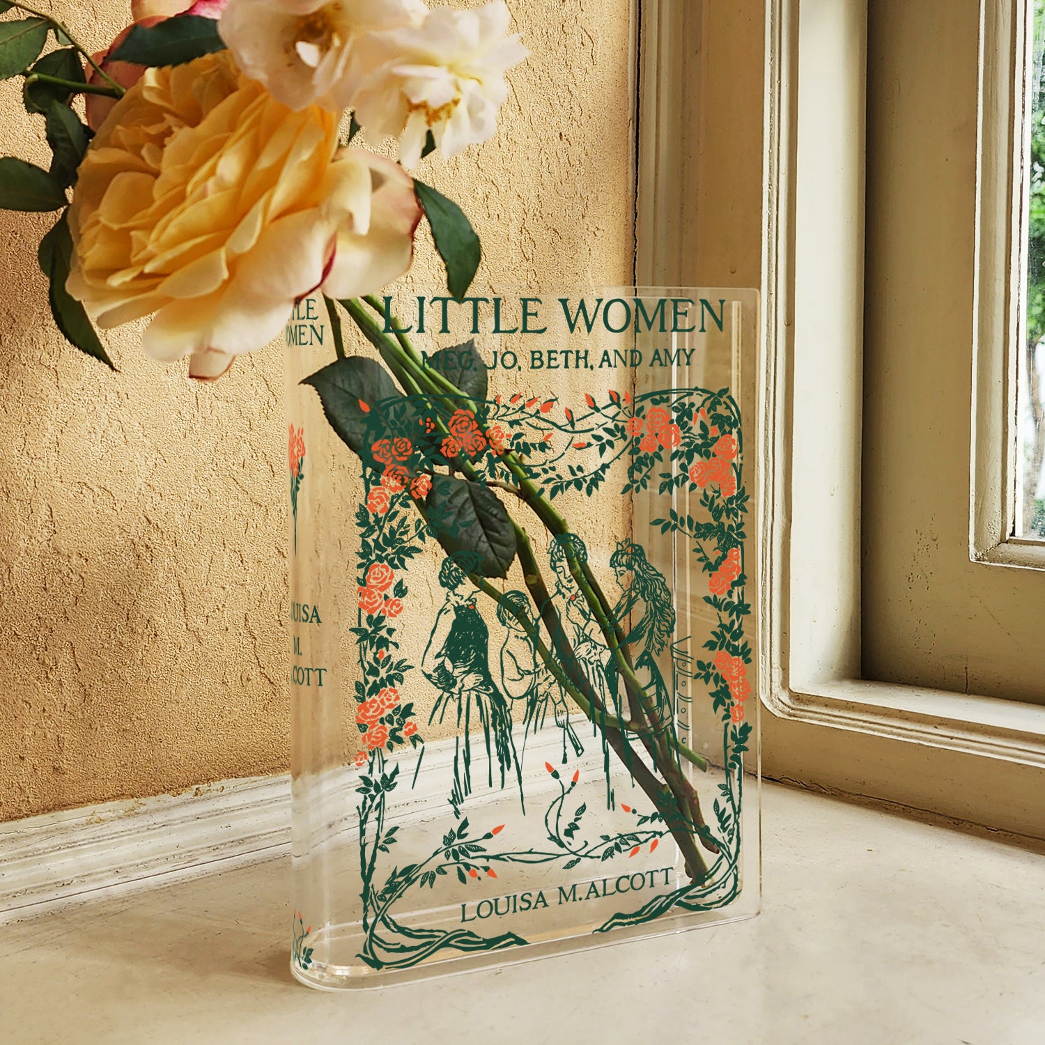 Acrylic book vase styled as 'Little Women' with roses on a windowsill