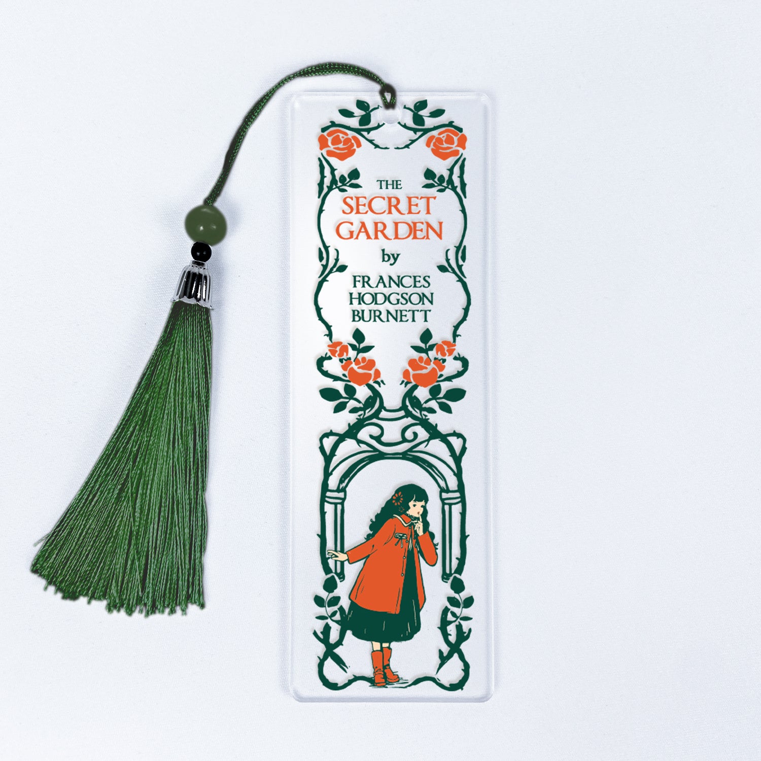 The Secret Garden bookmark with green tassel, floral design, and illustrated girl in red coat.