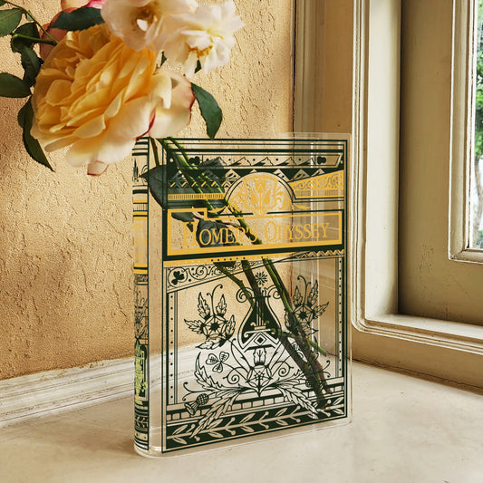 Acrylic book vase resembling Homer's Odyssey with roses inside on a windowsill