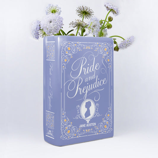 Pride and Prejudice ceramic book vase with purple flowers on white background