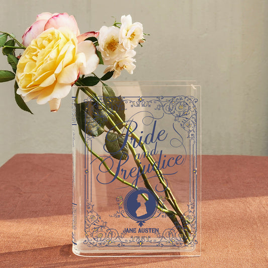 Pride and Prejudice acrylic book vase with fresh roses on a pink table