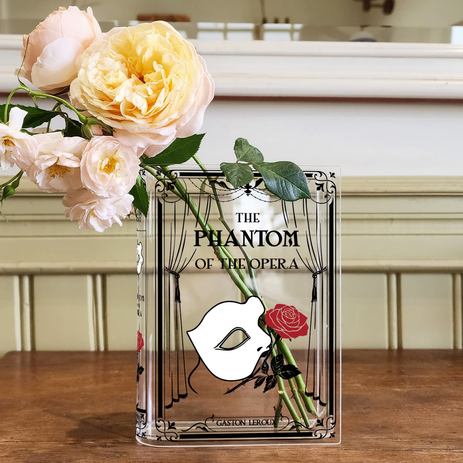 Phantom of the Opera acrylic book vase with roses on wooden table