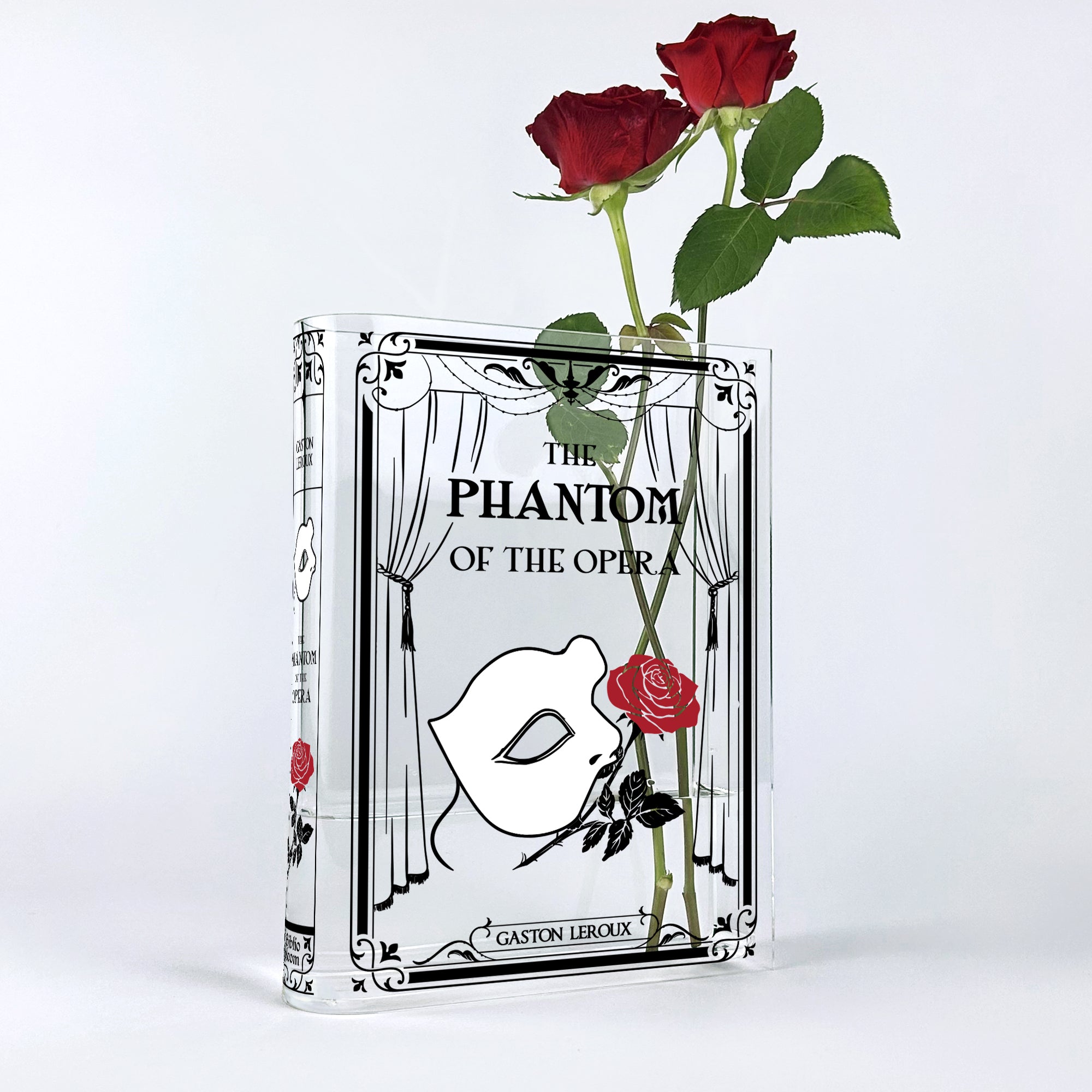 The Phantom of the Opera acrylic book vase with two red roses on white background
