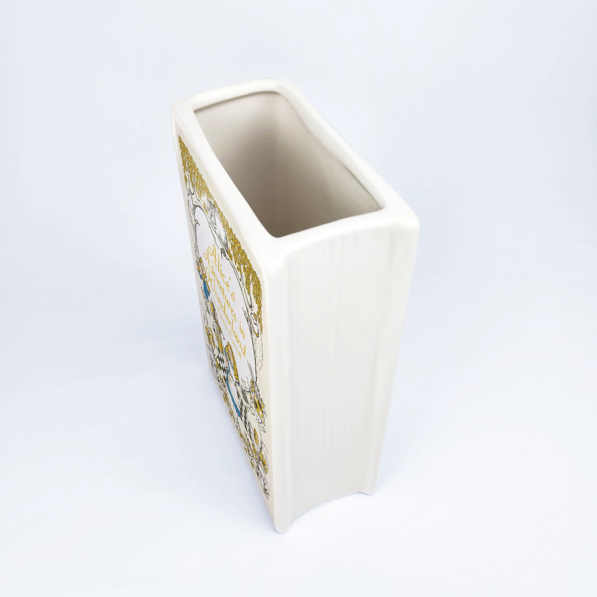 3621b91f-8b1f-43d0-ac2e-44e1e63c9709/alice_s_adventure_in_wonderland_II-Ceramic_book_vase_-_mockup_06_-_nghieng_tren_xu_ng.jpg