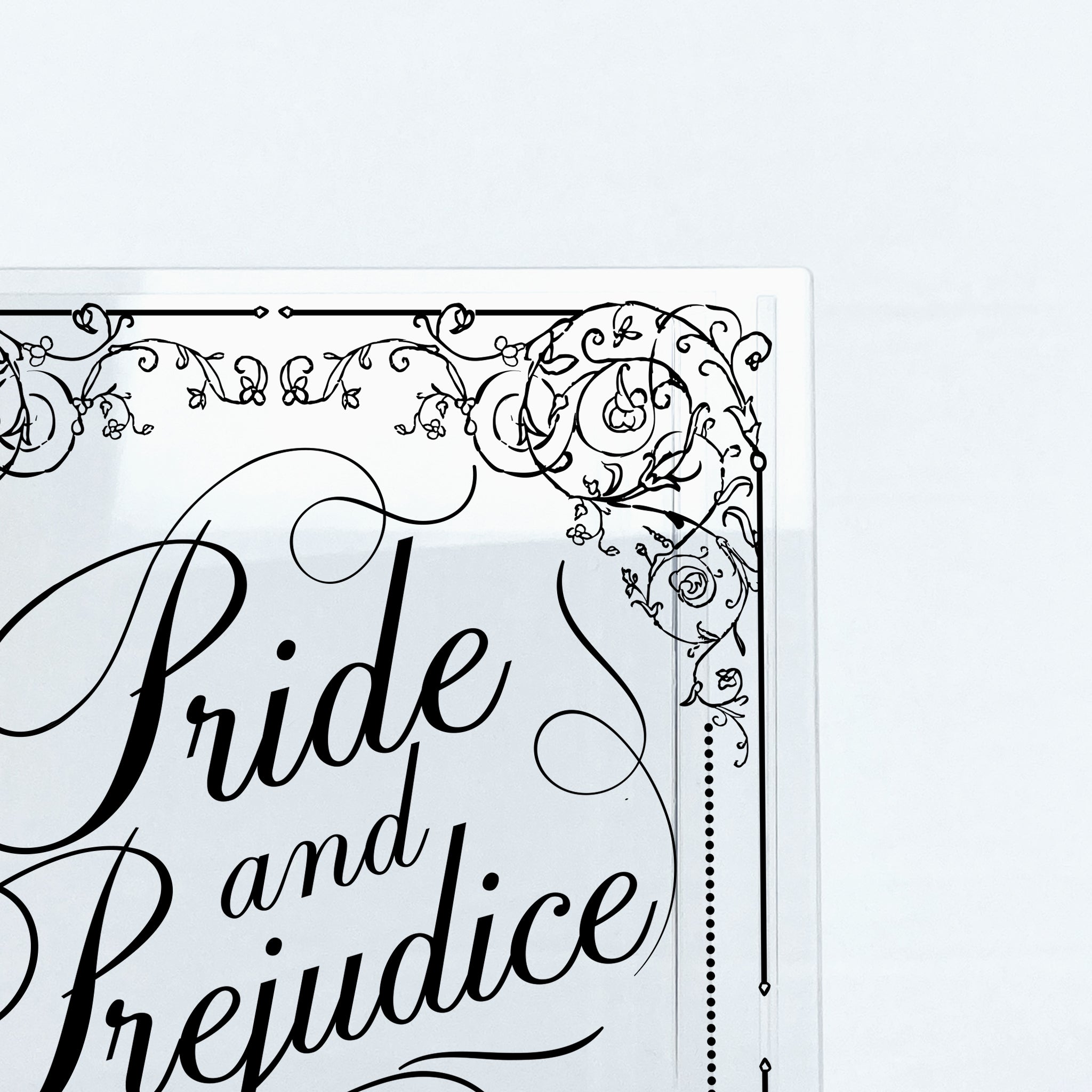 Pride and Prejudice book cover with ornate floral black lettering on white background