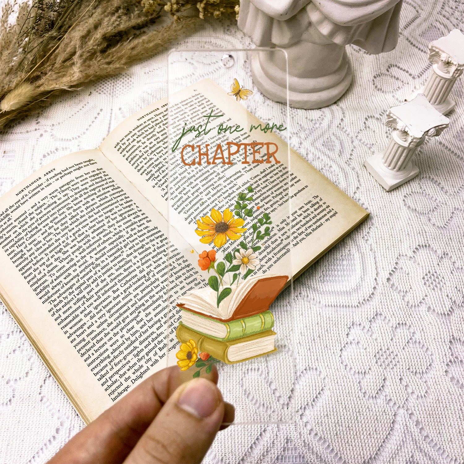 Transparent floral bookmark with 'just one more chapter' on open book, vintage decor
