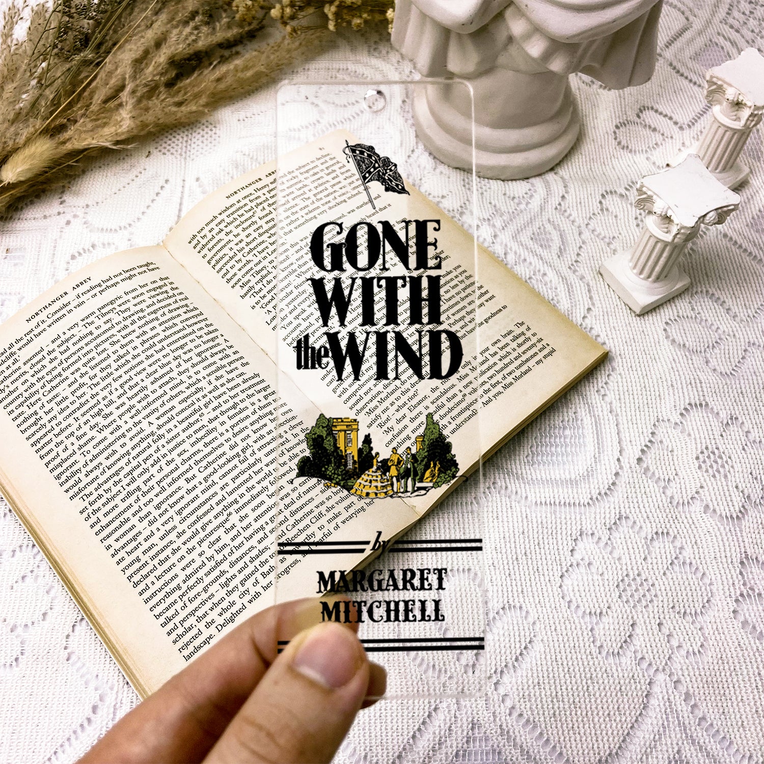 Gone with the Wind clear acrylic bookmark held over open book on lace tablecloth
